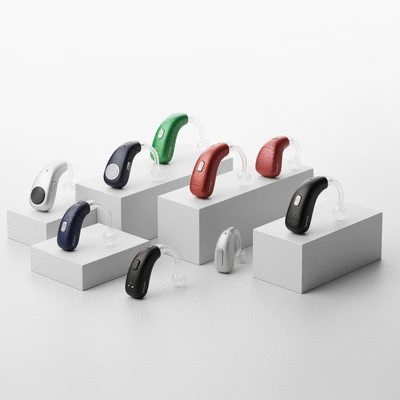 Assortment of modern hearing aids in various styles and colors, neatly arranged on a clean, light-colored surface, no text, no words, no typography, 8K, professional product photography